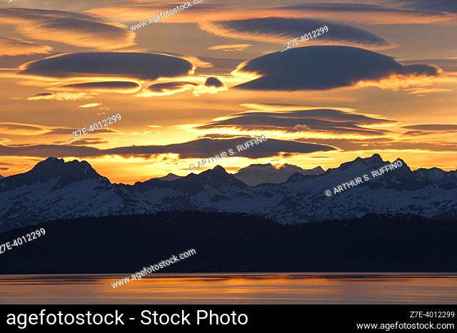 Midnight sun in Alaska highlighting lenticular clouds, Alaska, United States of America
