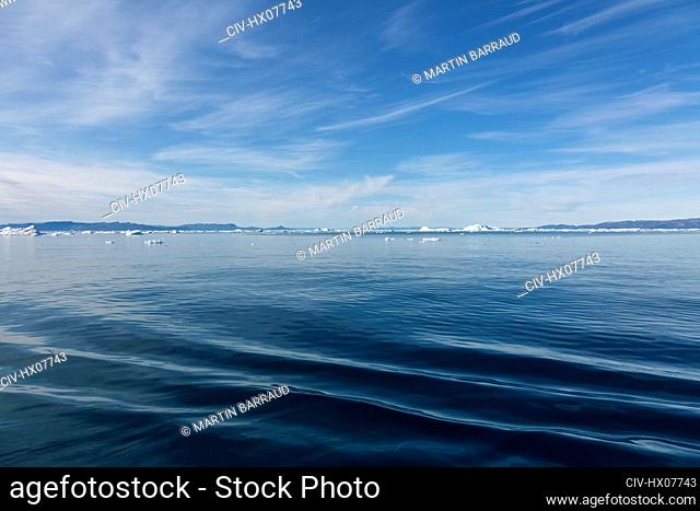 Polar ice melting on sunny vast blue Atlantic Ocean Greenland