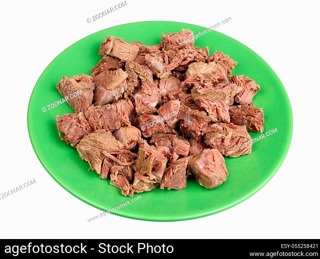 Boiled cut into small pieces meat of beef and veal - a basis of dietary food for hemoglobin restoration. Isolated on white studio closeup
