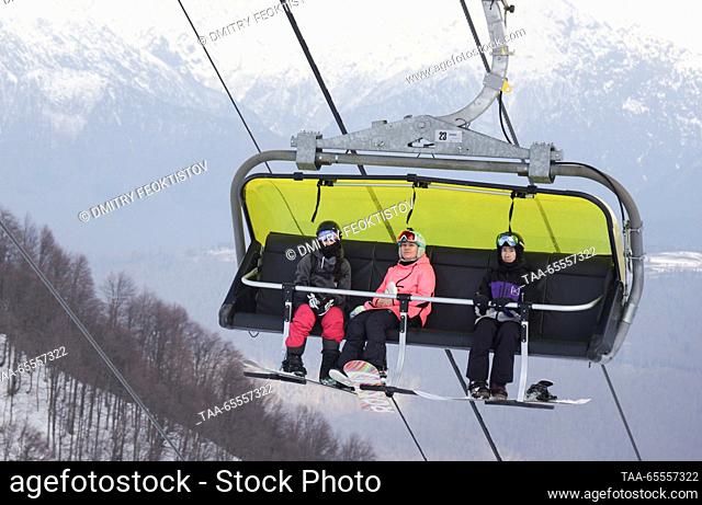 RUSSIA, SOCHI - DECEMBER 8, 2023: Snowboarders ride a chairlift at the Rosa Khutor mountain resort. Dmitry Feoktistov/TASS