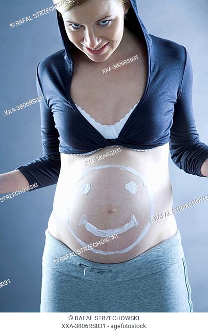 pregnant woman with cream on belly
