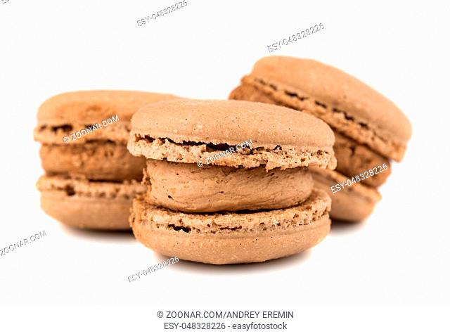Three brown french macaroon cookies isolated on white background