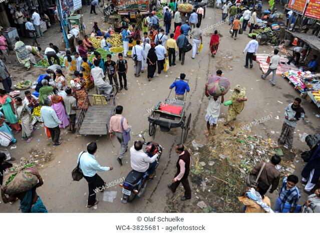 Kolkata (Calcutta), West Bengal, India, Asia - A view from above showing a handpulled rickshaw and crowds of people swarming in the daily street traffic of the...