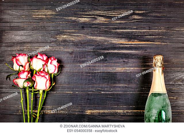 Champagne. Women's Day, 8 March. Champagne and roses on a wooden table. Valentine's Day. Birthday. Wedding. Anniversary. Rustic style