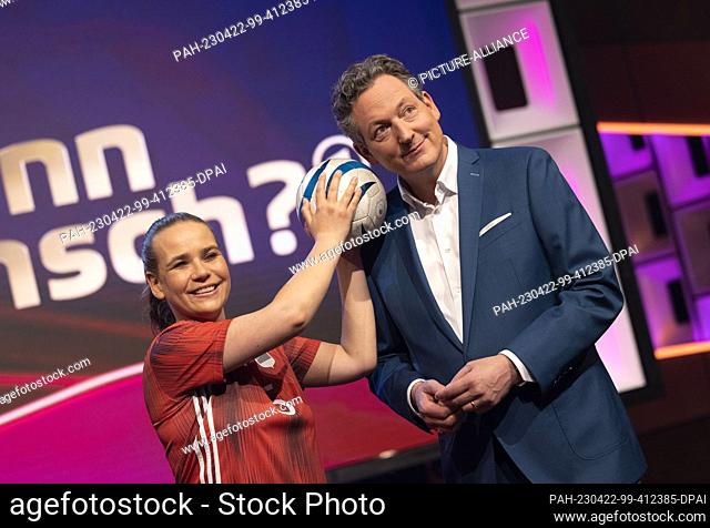 22 April 2023, North Rhine-Westphalia, Cologne: Presenter Eckart von Hirschhausen stands with blind soccer player Jana Marquart in the TV studio before the...