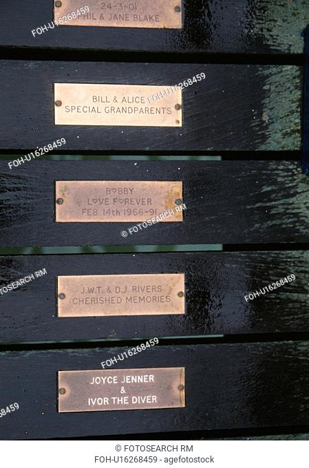 Close up of brass memorial tablets in Swanage