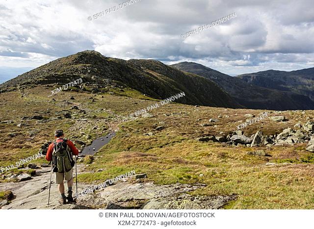 A hiker on the Appalachian Trail descending Mount Washington. Located in the White Mountains, New Hampshire USA