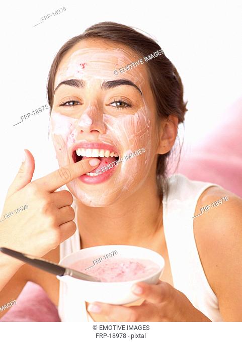Woman tasting fruit face mask