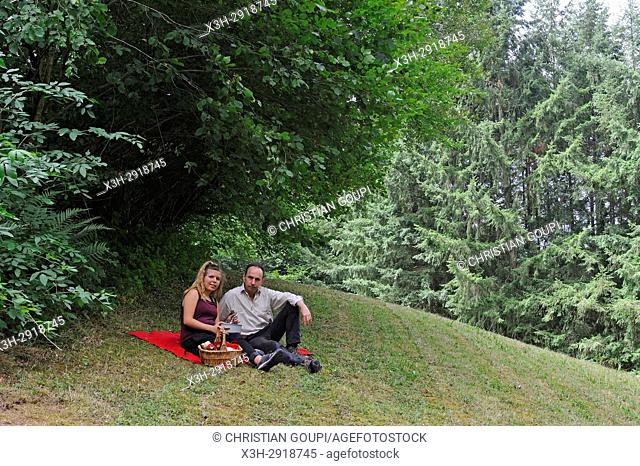 father and daughter having pic-nic in a meadow, Puy-de-Dome department, Auvergne-Rhone-Alpes region, France, Europe