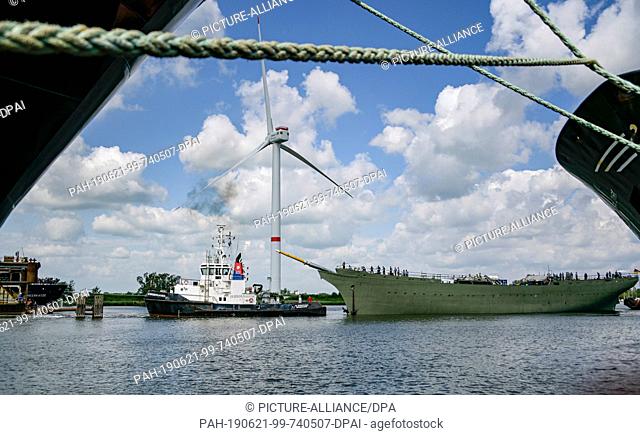 21 June 2019, Bremen, Bremerhaven: The naval training ship ""Gorch Fock"" (M right) is undocked from a dock of the Bredo shipyard by a tug