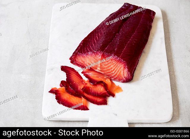 Beetroot cured salmon on cutting board
