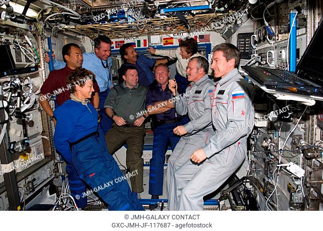 The STS-114 and Expedition 11 crewmembers gather in the Destiny laboratory of the International Space Station. From the left (front row) are astronaut Eileen M