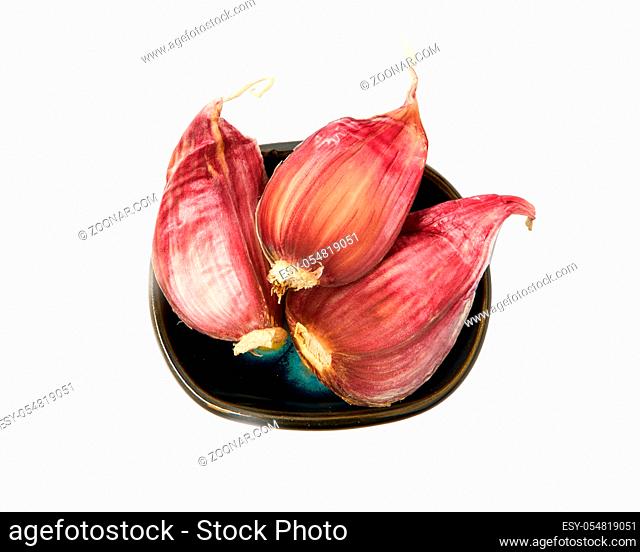 Garlic in a bowl isolated on a white background. Spice on isolate. View from above