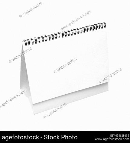 Blank real paper desk spiral calendar isolated on white background, front diagonal view