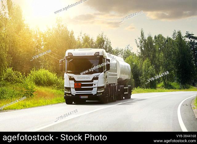 White Scania G500 tank truck transports gasoline, ADR code 33-1203, along highway on a beautiful summer morning. Salo, Finland. June 25, 2021