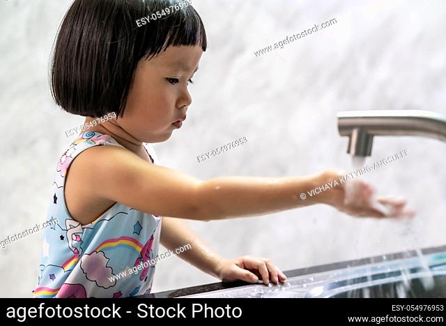 Asian girl washing her hand for hygiene. This behavior is good for health care and reduce infection of virus while coronavirus covid-19 pandemic
