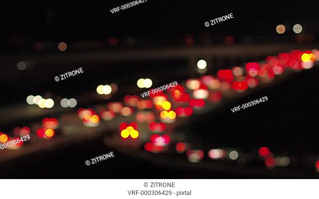 Drone footage of defocused cars on highway at night