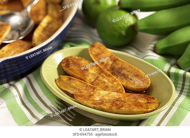 Baked Plantains in a Bowl, Baking Dish and Fresh Plantains