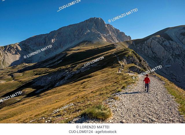 Hiker on the path to the summit of peak Corno Grande, Gran Sasso e Monti della Laga National Park, Abruzzo, Italy
