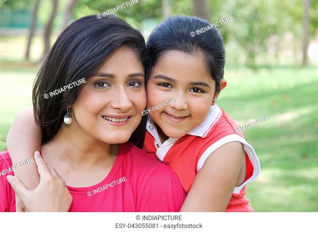 Portrait of mother and daughter in park