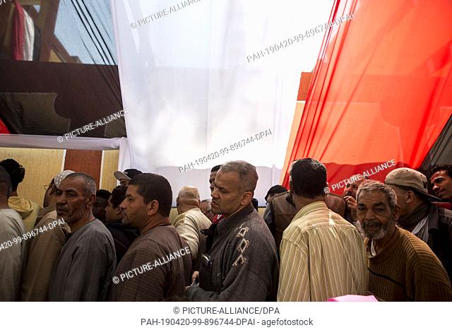 20 April 2019, Egypt, Cairo: Men stand in lines to take part in the first day of the national referendum on the constitutional amendments extending the...