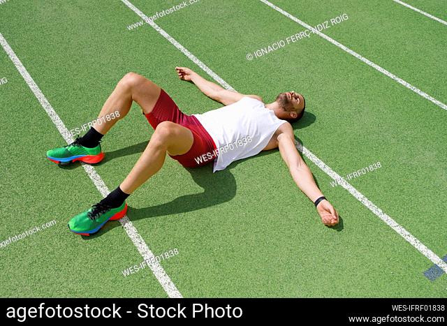 Athlete relaxing on running track