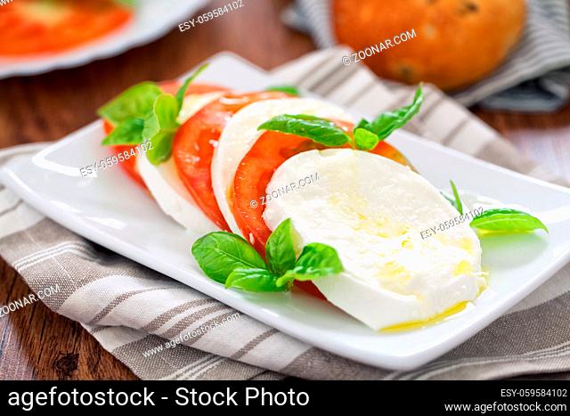 Caprese salad with mozzarella, tomatoes and fresh basil
