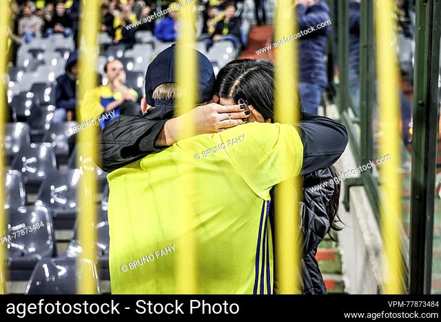 Sweden's supporters comfort each other during the suspended soccer game between Belgian national soccer team Red Devils and Sweden