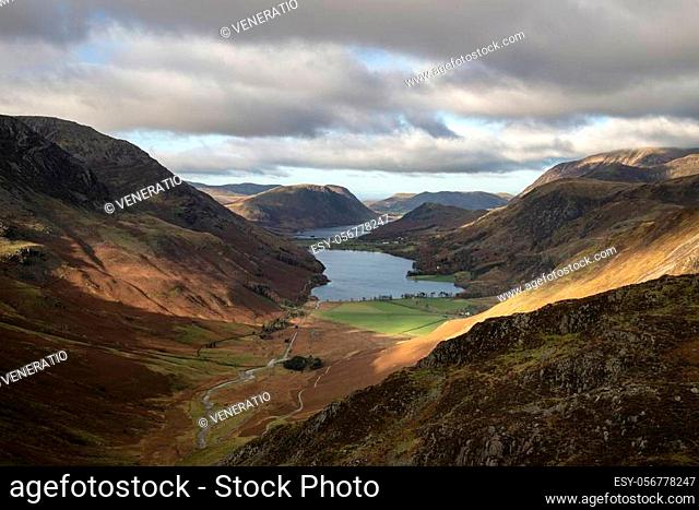 Epic Autumn Fall landscape of Buttermere and Crummock Water surrounded by mountain peaks in Lake District
