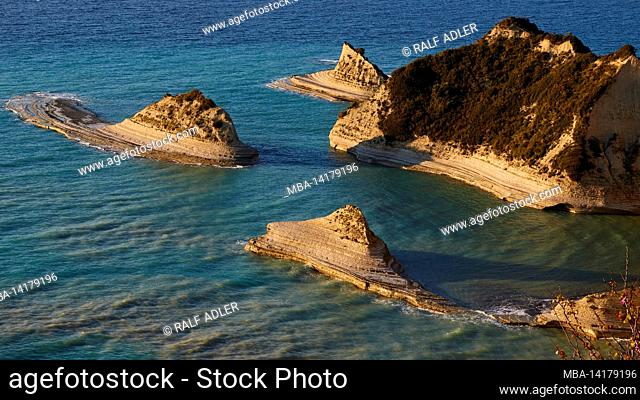 Greece, Greek Islands, Ionian Islands, Corfu, northwest of the island, Cape Drastis, evening light, sandstone cliffs and offshore islets made of sandstone