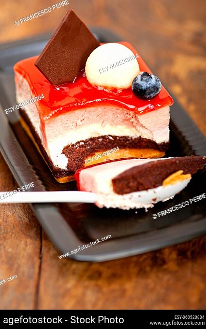 fresh strawberry yogurt mousse with macaroon and blueberry on top