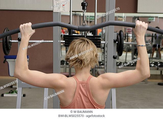 Young woman doing back muscles workout