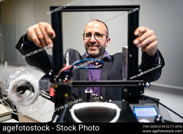 23 April 2020, Bavaria, Kulmbach: Wolfgang Lormes, graduate physicist and teacher at Markgraf-Georg-Friedrich-Gymnasium, sets up one of his 3D printers