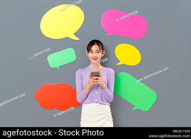 Holding a mobile phone young girl standing in front of the dialog box