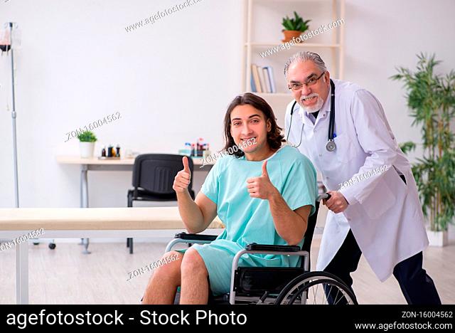 Young patient in wheel-chair and experienced doctor traumatologist
