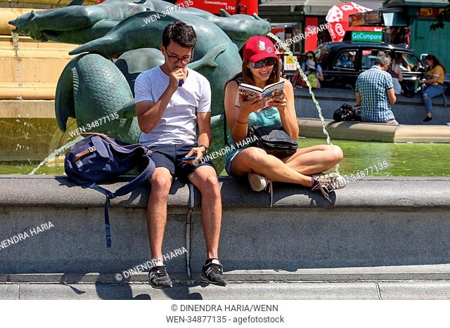 Londoners and tourists enjoy on another hot and humid day in the Trafalgar Square. Dry and hot weather is likely to continues in Britain for the rest of the...