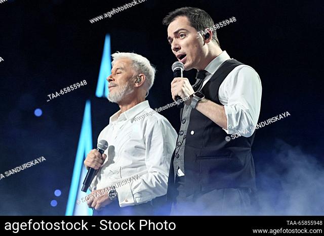RUSSIA, MOSCOW - DECEMBER 17, 2023: Russian singers Oleg Gazmanov (L) and Rodion Gazmanov perform during a New Year concert at the MTS Live Hall