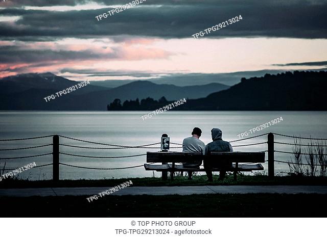 two people sitting on bench