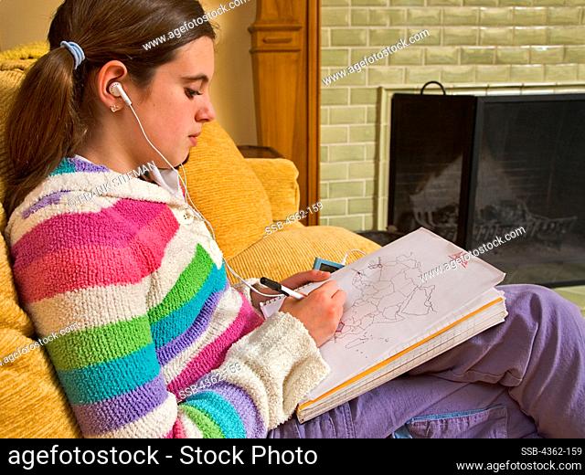 Girl Doing Homework While Listening to Music