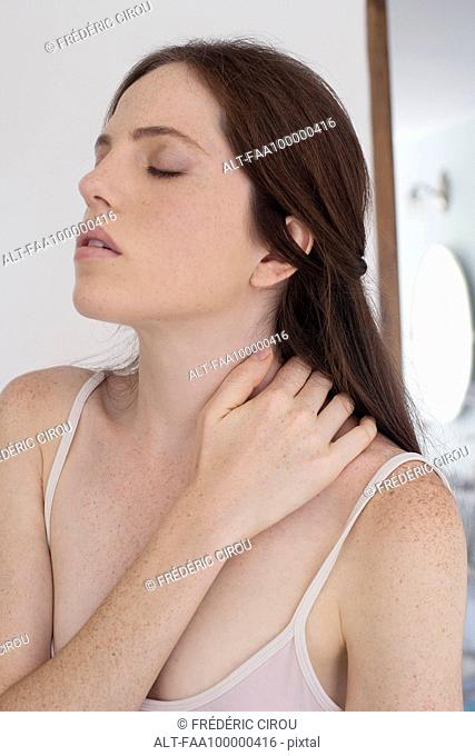 Woman massaging neck