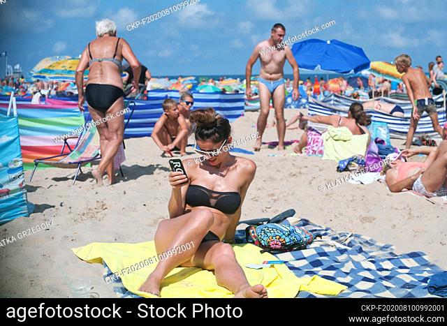 Poland, Wladyslawowo, popular Baltic sea resort 10.08.2015. The girl with a smartphone in the beach. photo CTK/Grzegorz Klatka