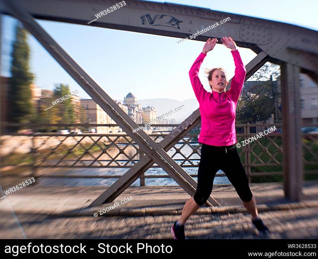 runner  woman warming up and stretching before morning jogging