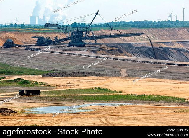 Brown coal open pit landscape with enormous digging excavator in Garzweiler mine Germany
