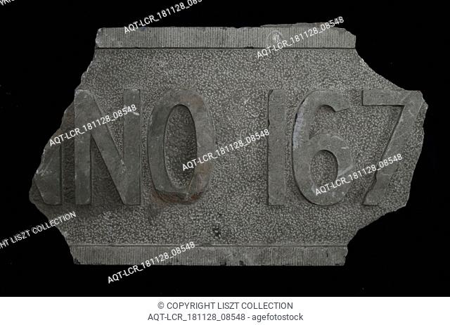 Fragment of facing brick with text ... NO 167 .., facing brick foundation stone building part stone, chopped rectangular frame and text in high relief Hard...
