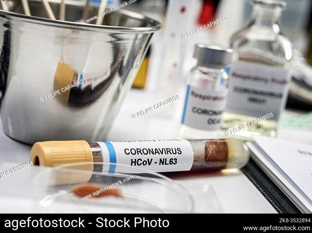 Vial with sample of covid-19 coronavirus infected person in a laboratory, conceptual image