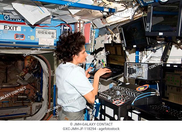 NASA astronaut Sunita Williams, Expedition 33 commander, uses a computer in the Destiny laboratory of the International Space Station