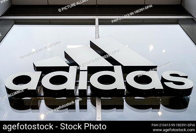 12 April 2021, Berlin: The company's logo hangs on the façade of the Adidas store on Tauentzienstrasse. Big brand manufacturers like Adidas, Miele and Co