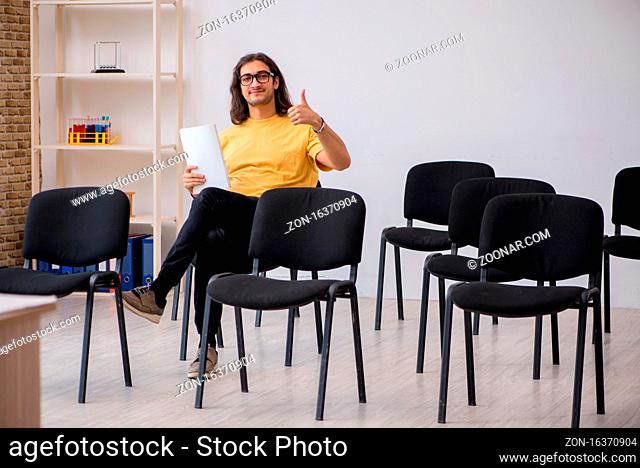Young student waiting for teacher in the classroom