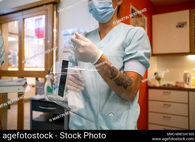 A nurse getting ready at the Intensive care unit of the Liege hospital which is badly impacted by Covid 19. Liege, Belgium