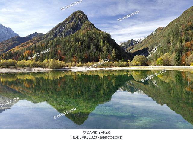 Julian Alps, Peaks of Prisojnik and Razor reflected in pools beside the Velika Pisnca river in autumn